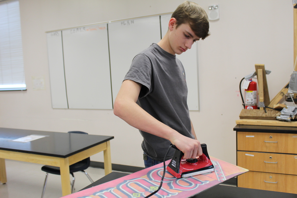 GVHS student waxing his snowboard